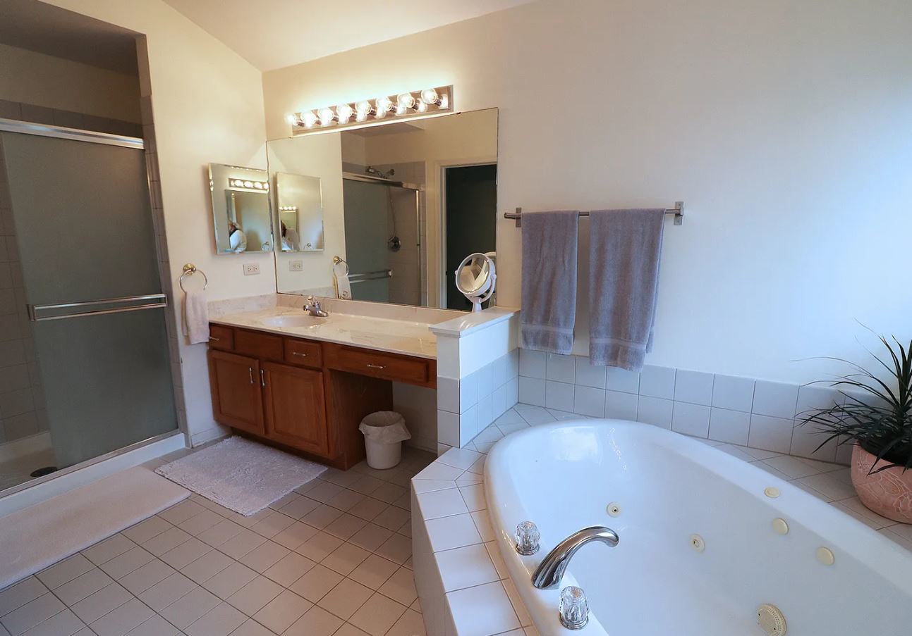37076 North Bonnie Brae Road Lake Villa, IL 60046 - Photo 9 of 17 a bathroom with a tub sink and mirror