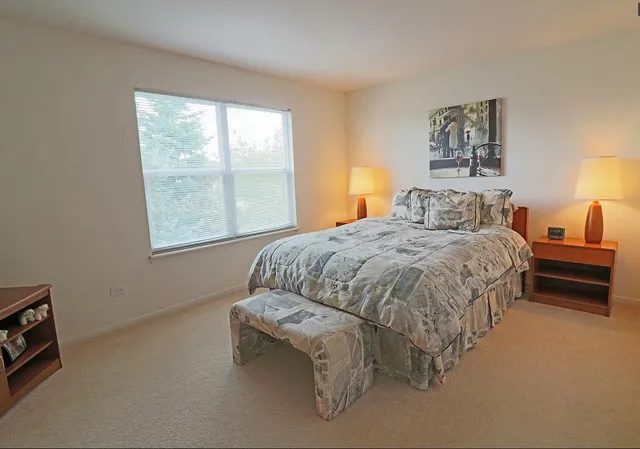 a bedroom with a bed and a window