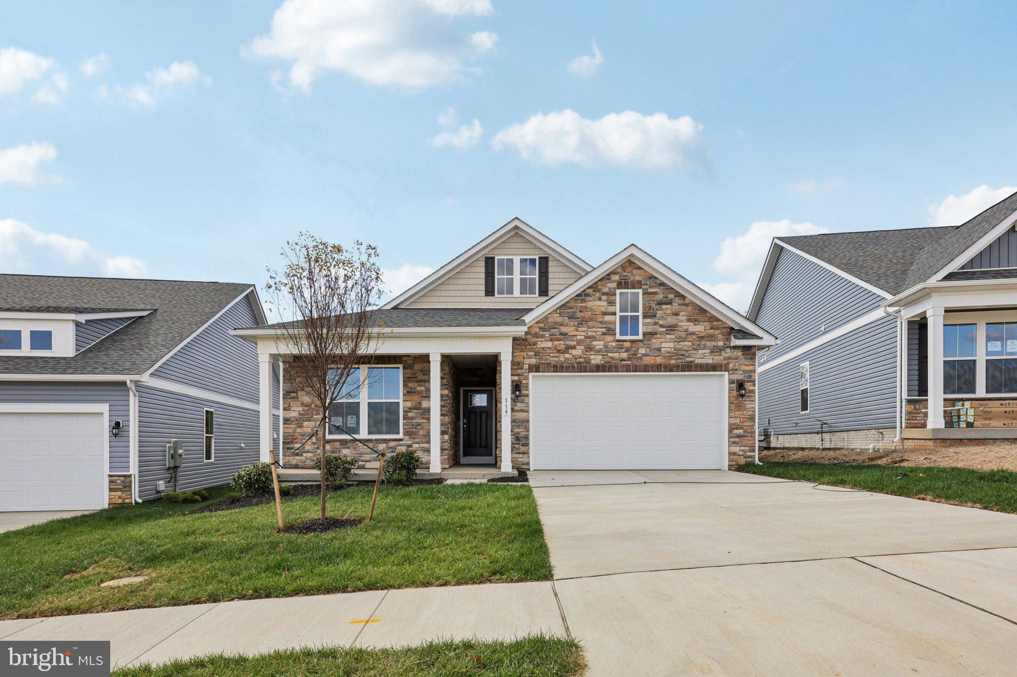 234 Hydrangea Way Winchester, VA 22602 - Photo 2 of 54 a front view of a house with a garden and yard