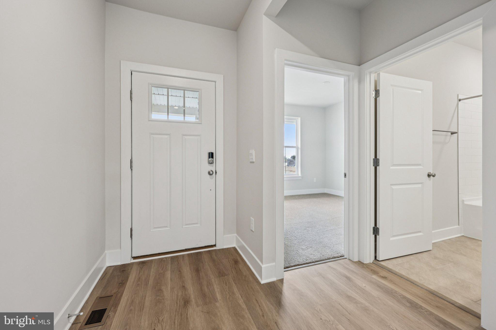 234 Hydrangea Way Winchester, VA 22602 - Photo 3 of 54 an empty room with wooden floor and windows