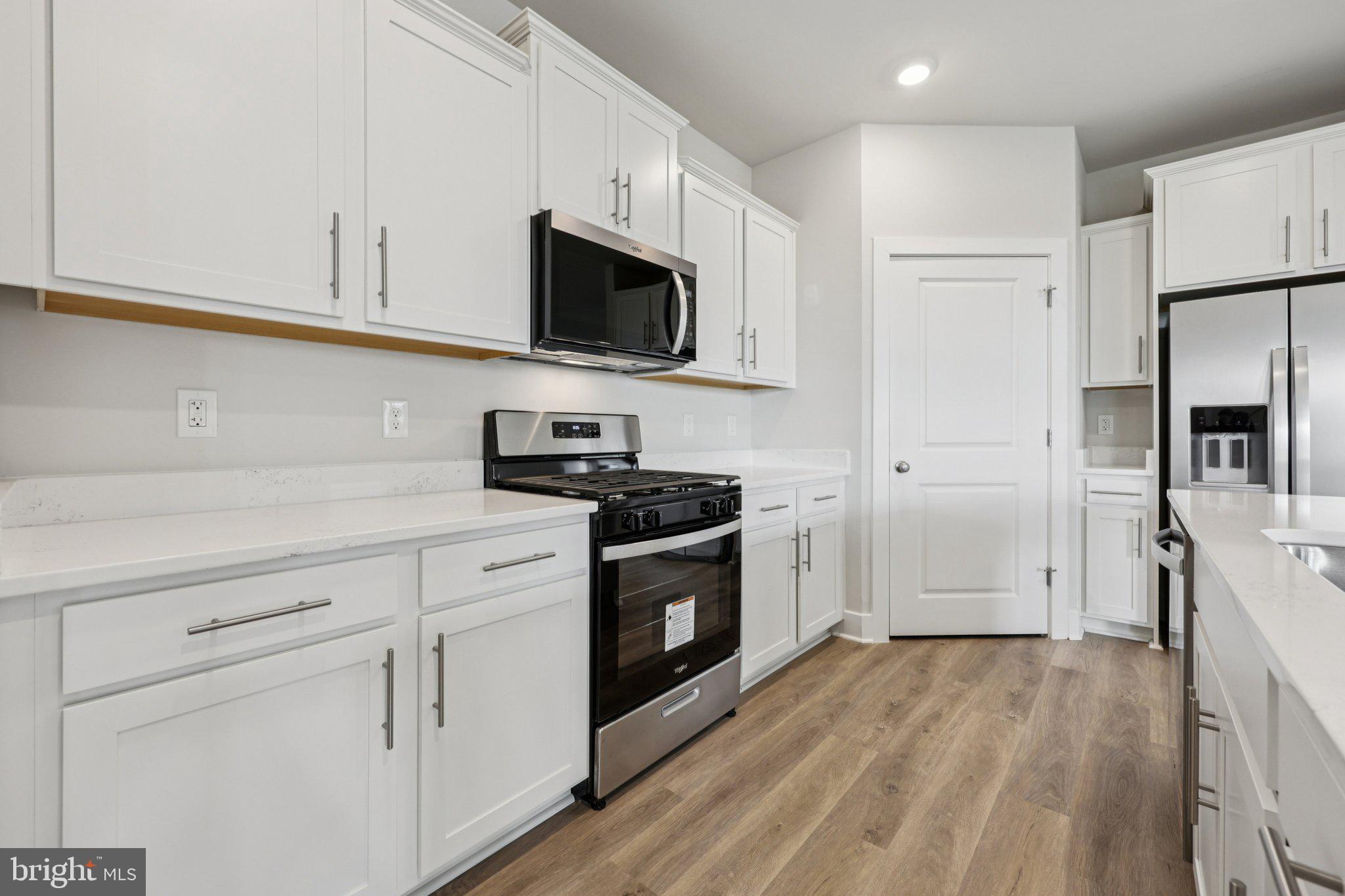 234 Hydrangea Way Winchester, VA 22602 - Photo 10 of 54 a kitchen with white cabinets stainless steel appliances and sink