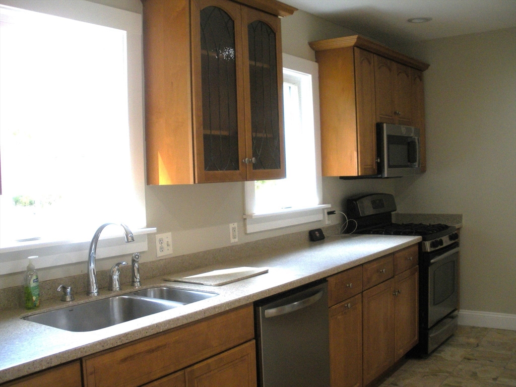 113 Rockland Street, Unit 1 Canton, MA 02021 - Photo 2 of 9 a kitchen with a sink and a window