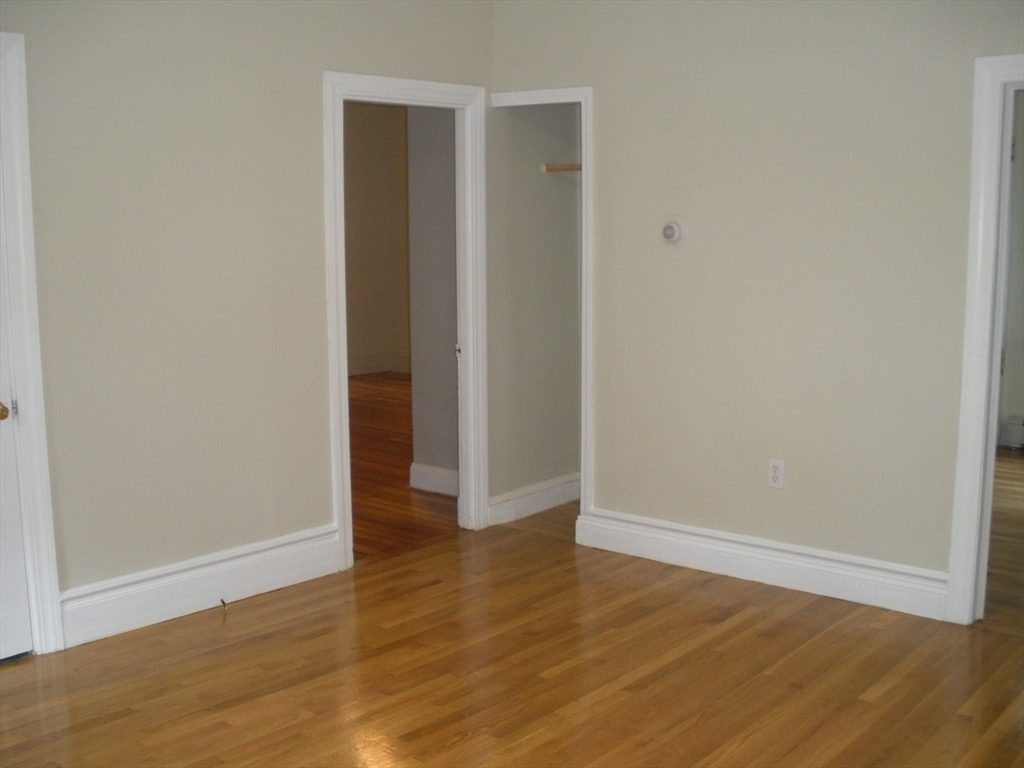 113 Rockland Street, Unit 1 Canton, MA 02021 - Photo 4 of 9 a view of an empty room with wooden floor