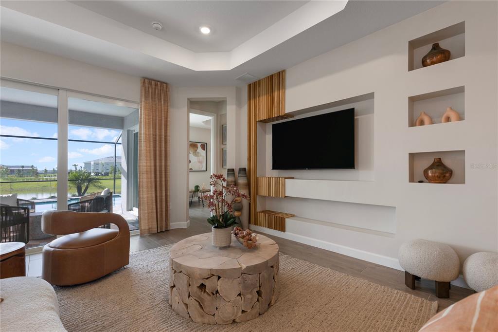 7157 Inlet Isles Lakewood Ranch, FL 34202 - Photo 13 of 26 a living room with furniture and a flat screen tv