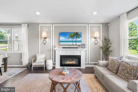 a living room with furniture a fireplace and a large window