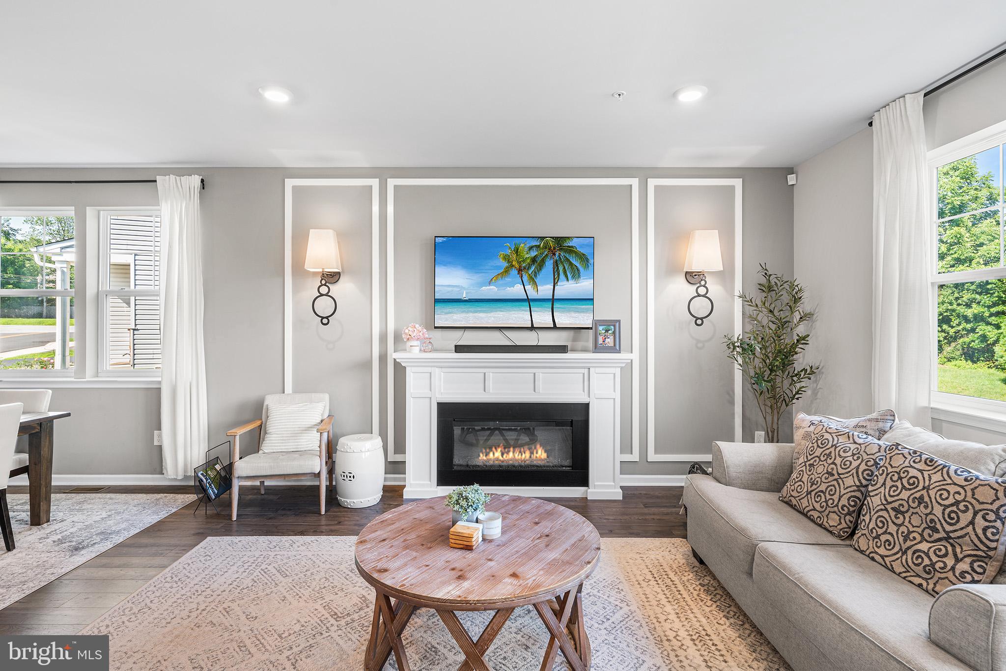 43 Hummingbird Lane Phoenixville, PA 19460 - Photo 12 of 44 a living room with furniture a fireplace and a large window