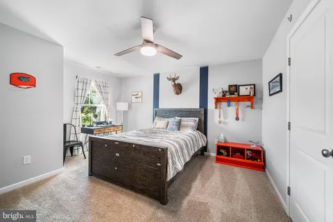 a spacious bedroom with a bed and a chandelier