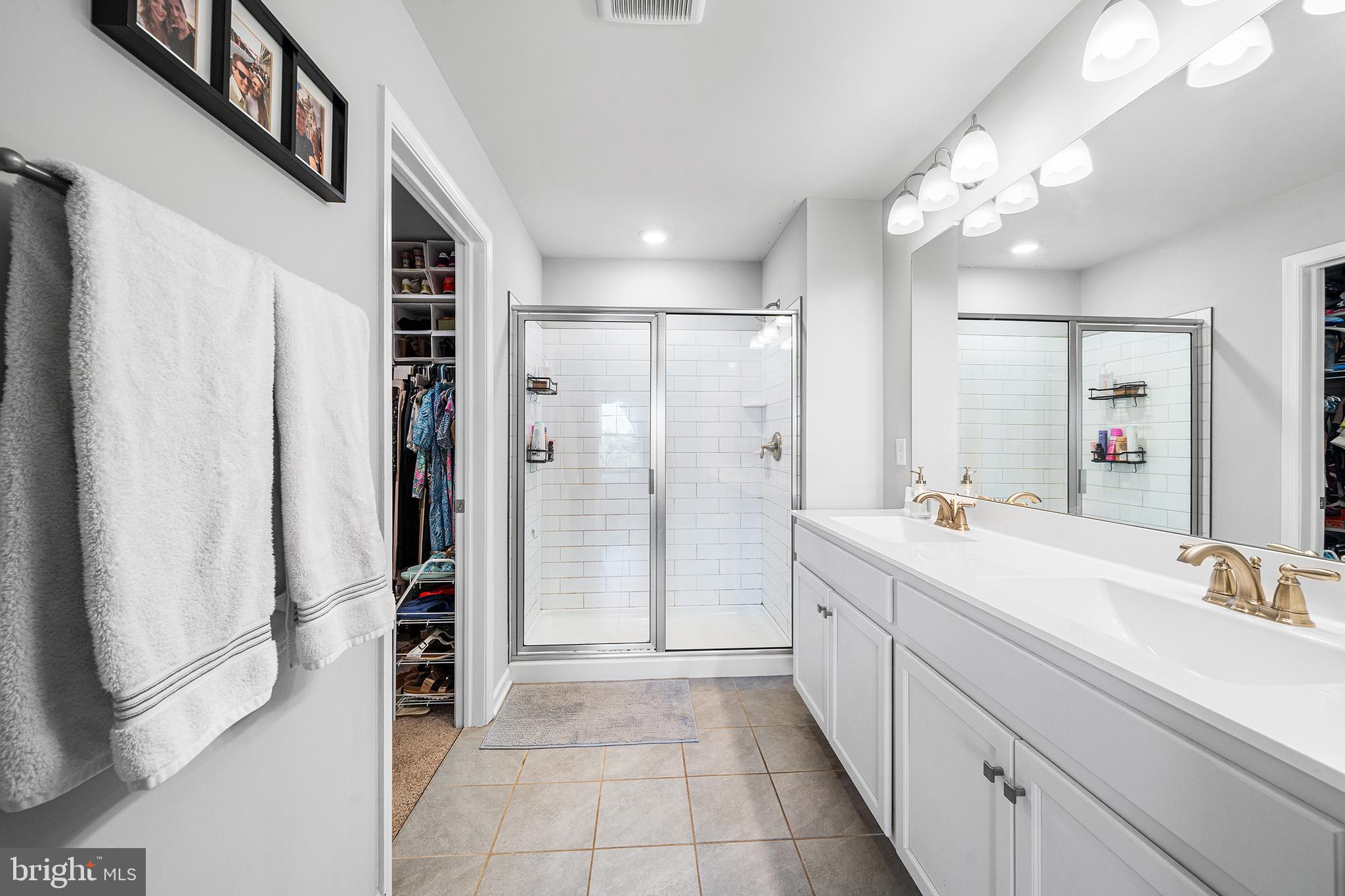 43 Hummingbird Lane Phoenixville, PA 19460 - Photo 28 of 44 a bathroom with a double vanity sink a shower and a mirror