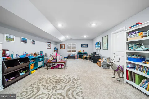 a bed room with furniture and a book shelf
