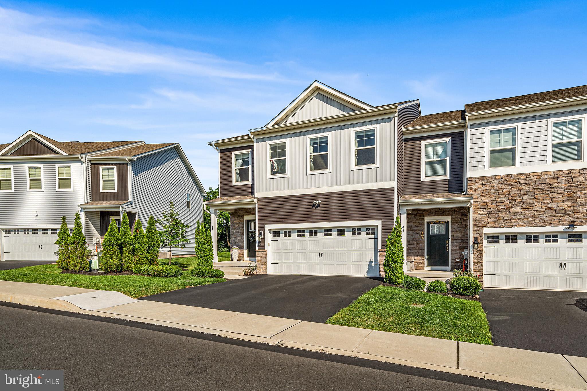 43 Hummingbird Lane Phoenixville, PA 19460 - Photo 35 of 44 a front view of a house with a yard and garage