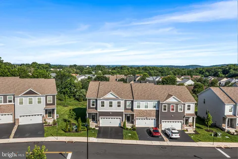 an aerial view of residential houses with city view