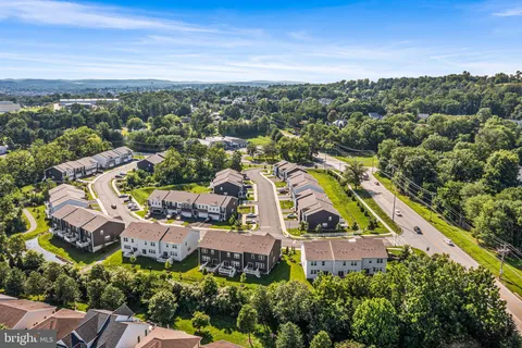 an aerial view of residential house with outdoor space and swimming pool