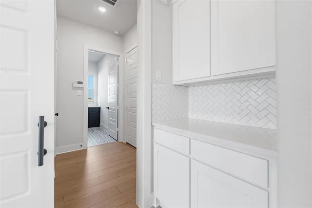wooden floor in an empty room with a fireplace