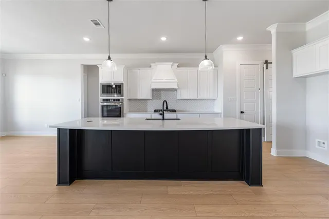 a kitchen with stainless steel appliances granite countertop a stove and a refrigerator