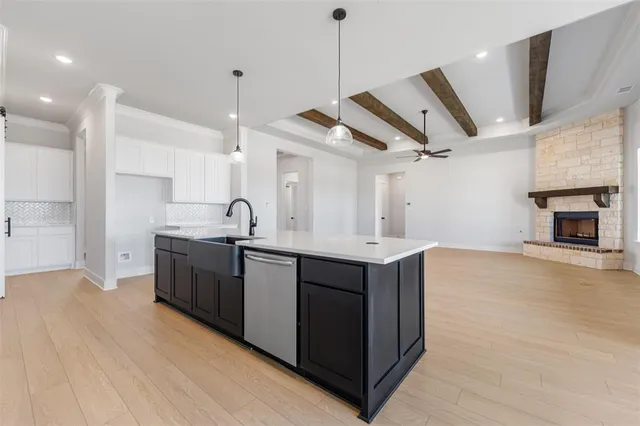a kitchen with stainless steel appliances kitchen island granite countertop a stove a sink and a microwave