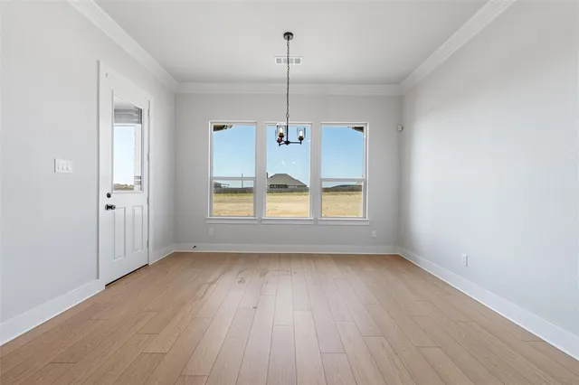 a view of a livingroom with a fireplace a ceiling fan and windows