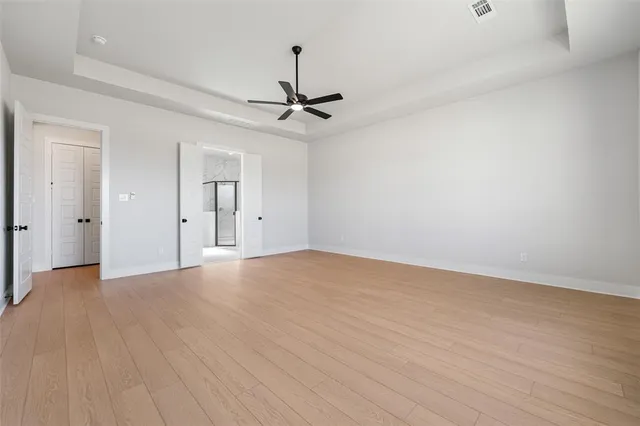a large white bathroom with a double vanity sink a large mirror and a bathtub