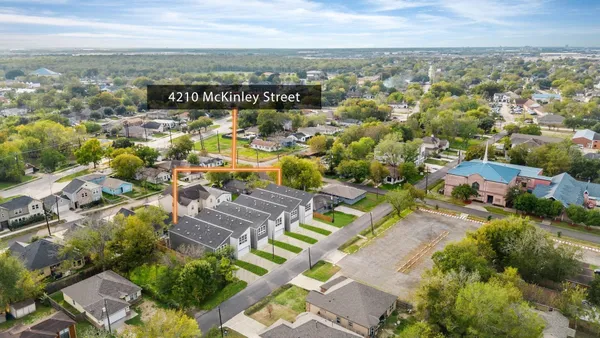 an aerial view of residential houses with outdoor space