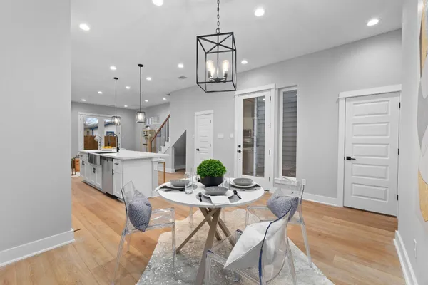 a dining room with furniture and wooden floor