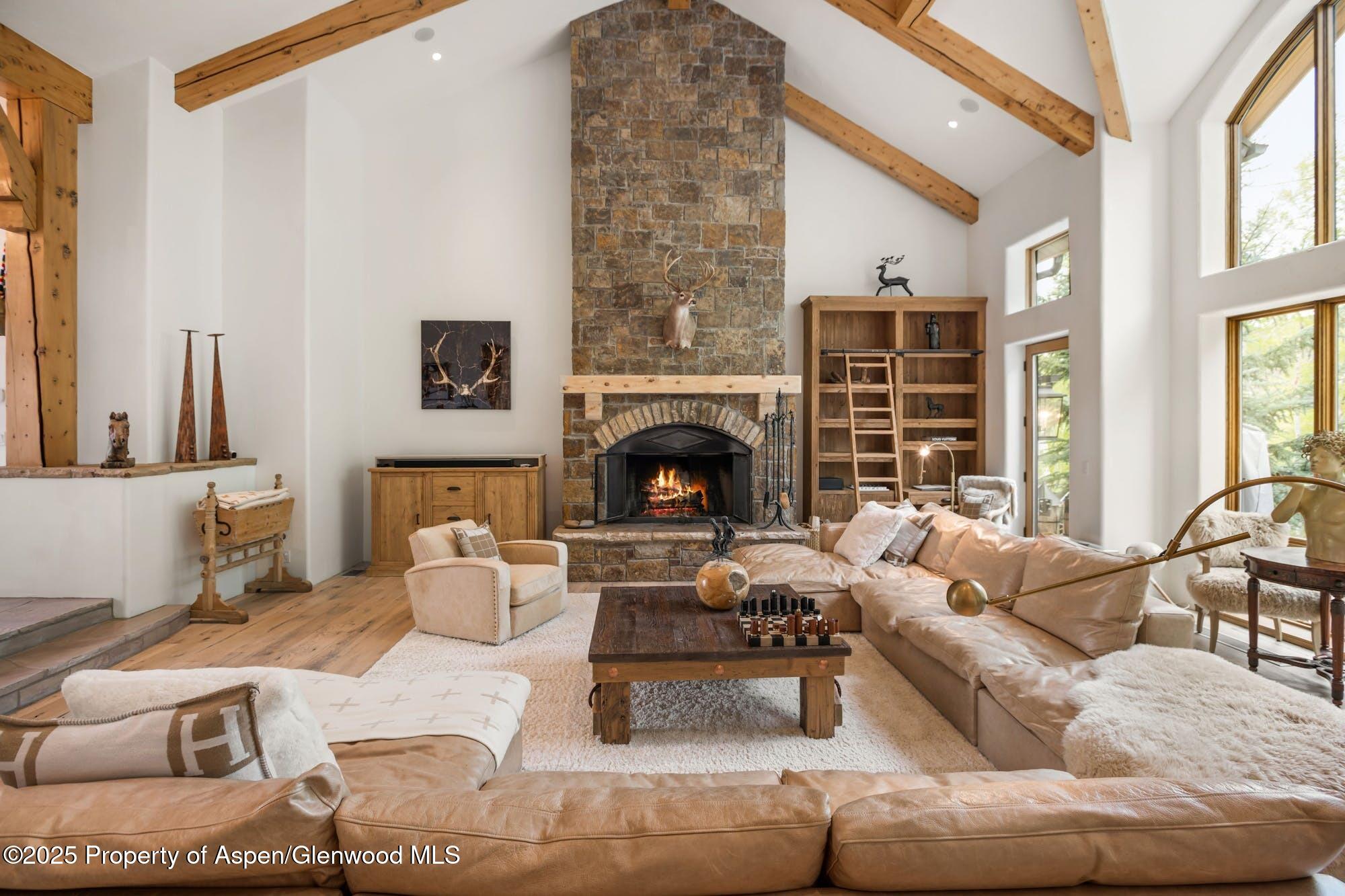 350 Spruce Ridge Lane Snowmass Village, CO 81615 - Photo 1 of 38 a living room with furniture and a fireplace