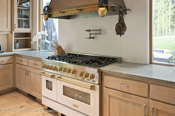 a stove top oven sitting inside of a kitchen