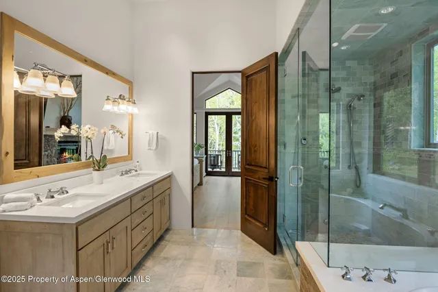 a bathroom with a double vanity sink and a mirror