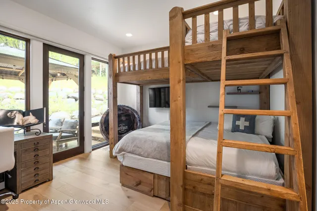 a bedroom with furniture and a large window