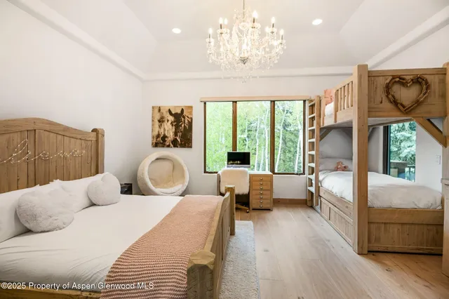 a bedroom with furniture and a large window