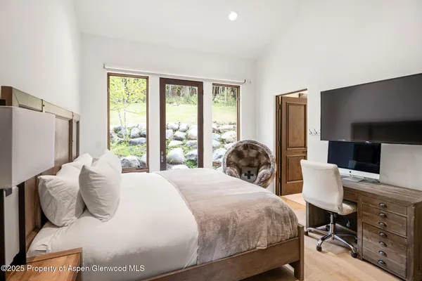 a bedroom with a bed and a flat screen tv