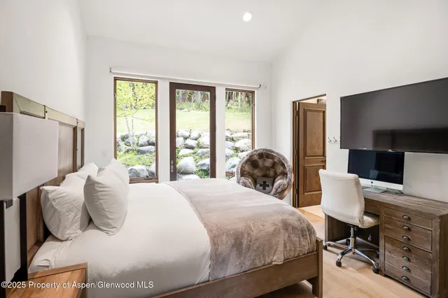 a bedroom with a bed and a flat screen tv