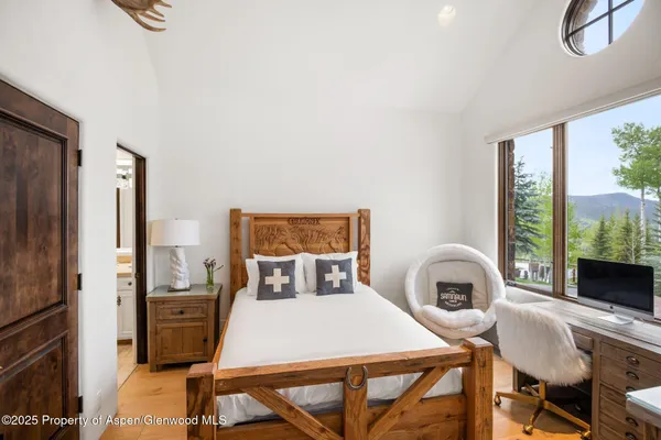 a bedroom with a bed and a table