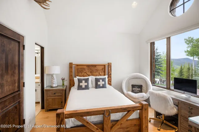 a bedroom with a bed and a table