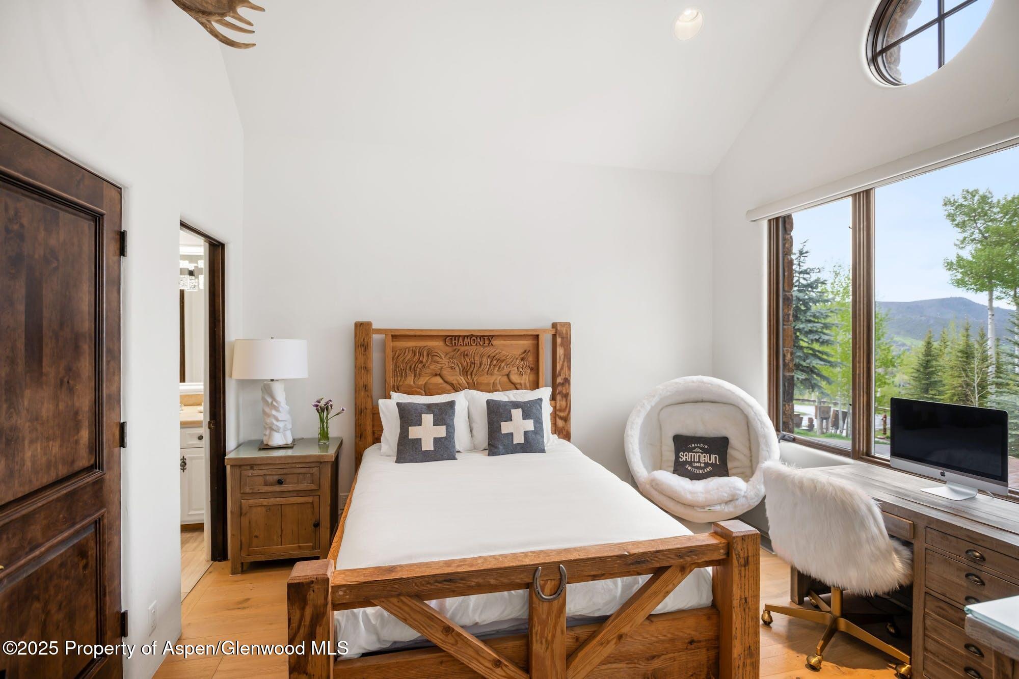 350 Spruce Ridge Lane Snowmass Village, CO 81615 - Photo 26 of 38 a bedroom with a bed and a table