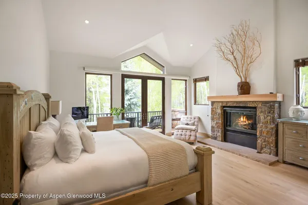 a bedroom with a bed and a fireplace