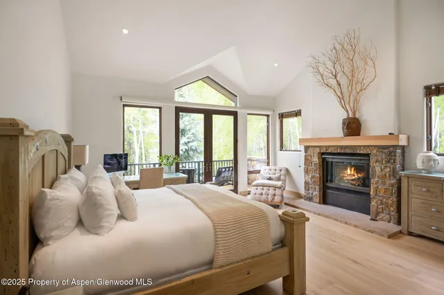 a bedroom with a bed and a fireplace