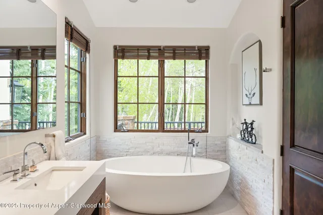 a bath tub sitting next to a window