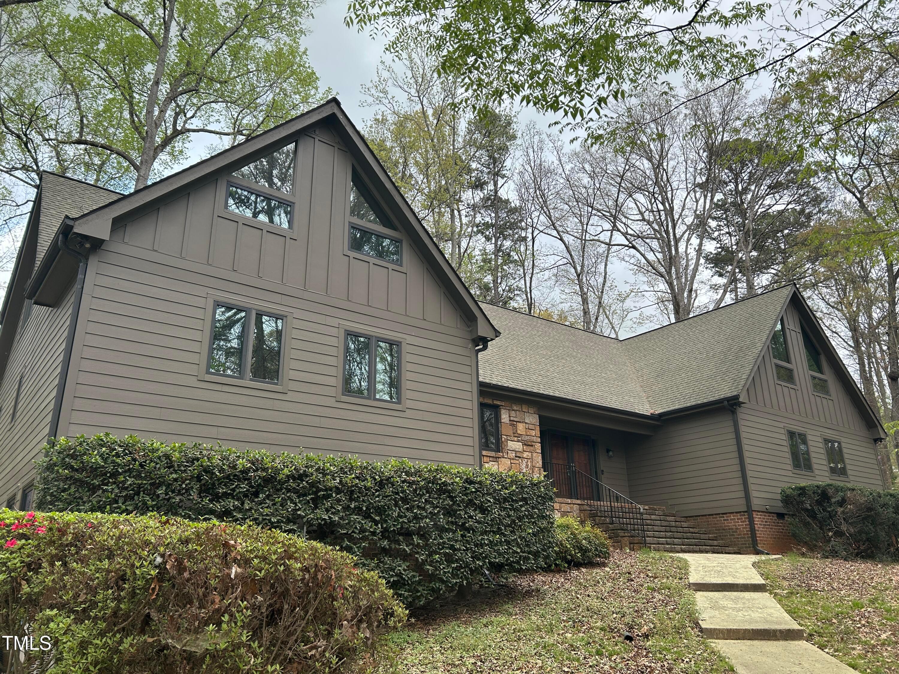 a front view of a house with a garden