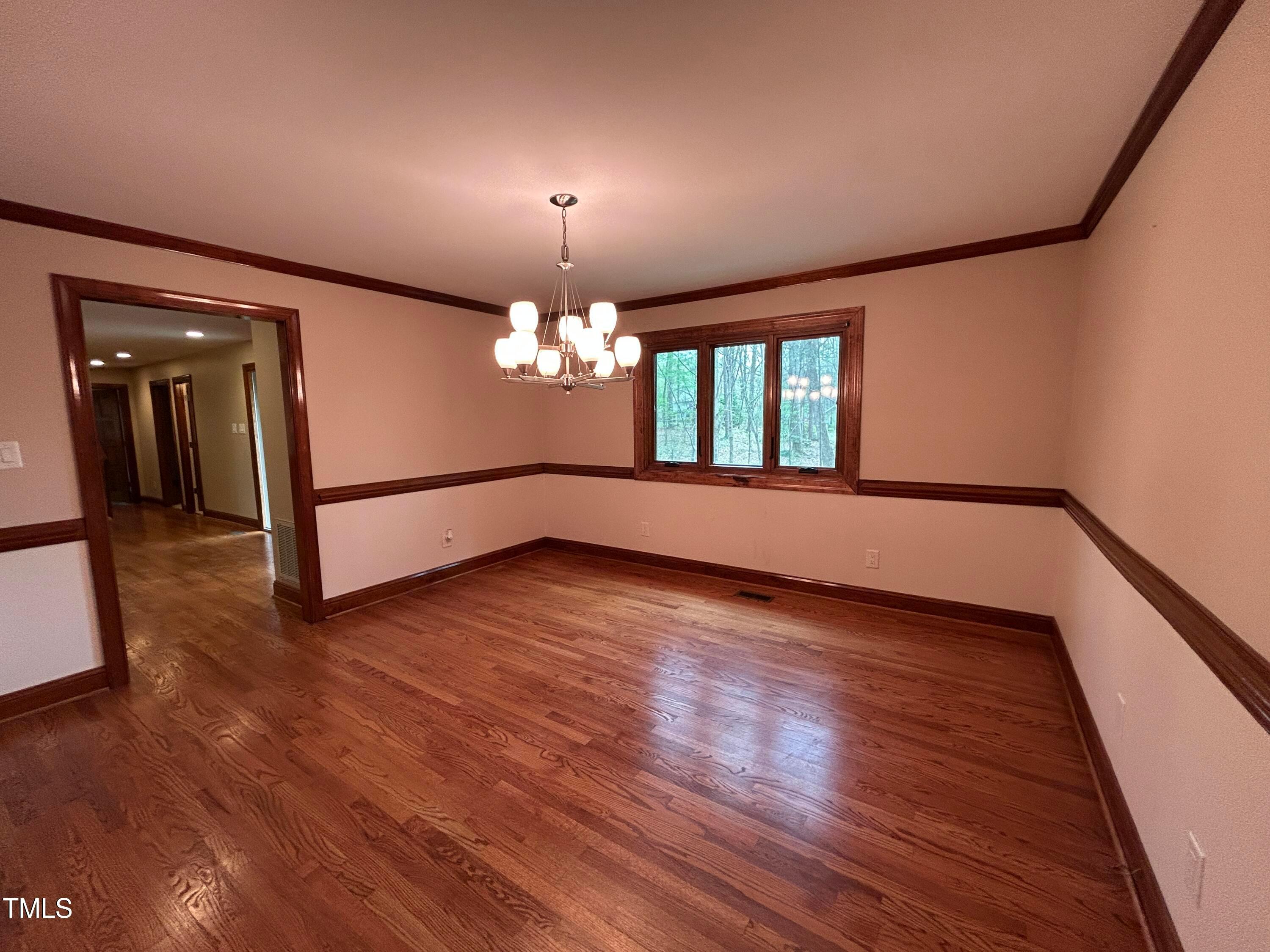 106 Springbrook Place Cary, NC 27518 - Photo 17 of 49 a view of a room with wooden floor and chandelier
