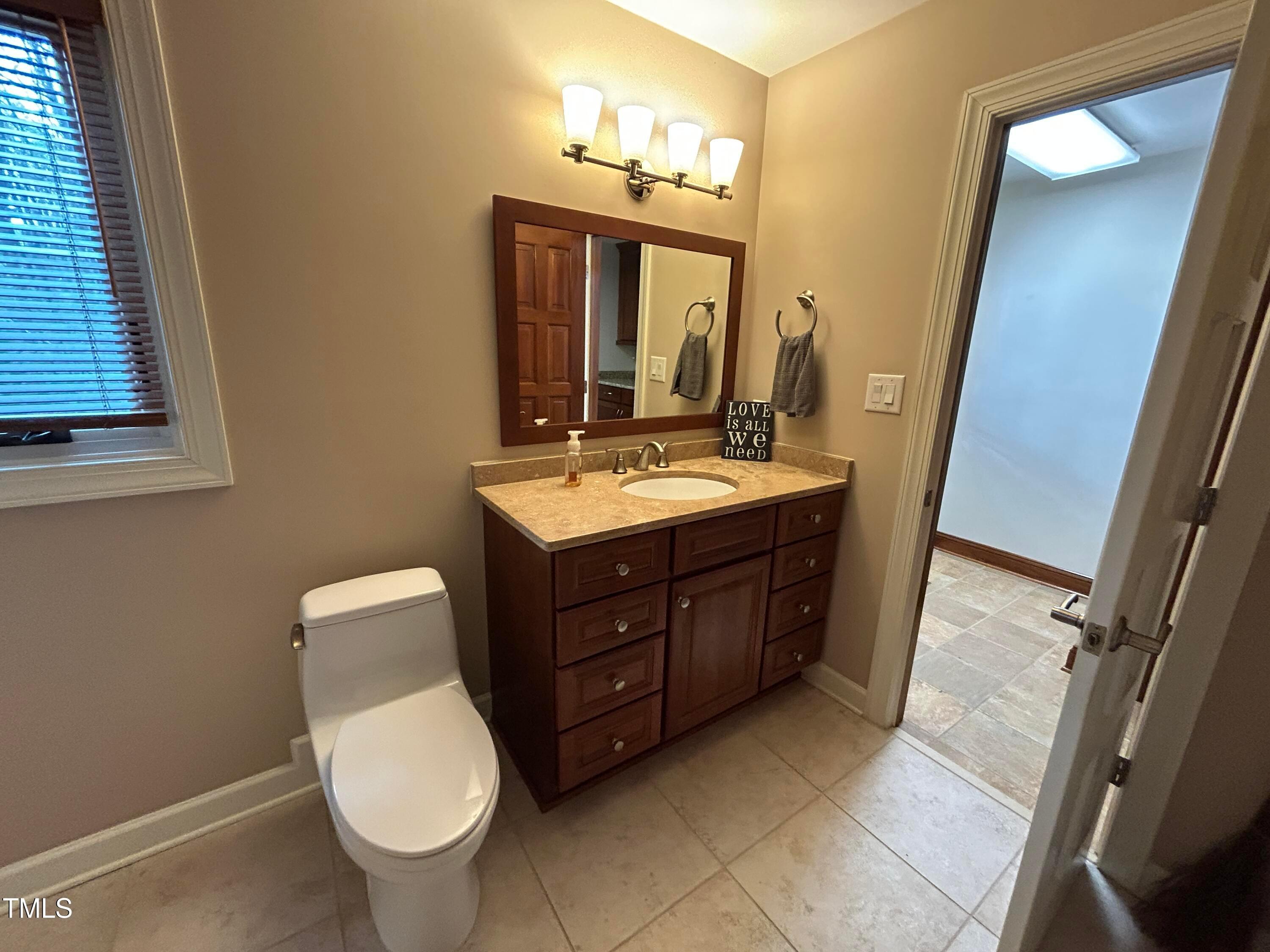 106 Springbrook Place Cary, NC 27518 - Photo 20 of 49 a bathroom with a toilet sink and mirror