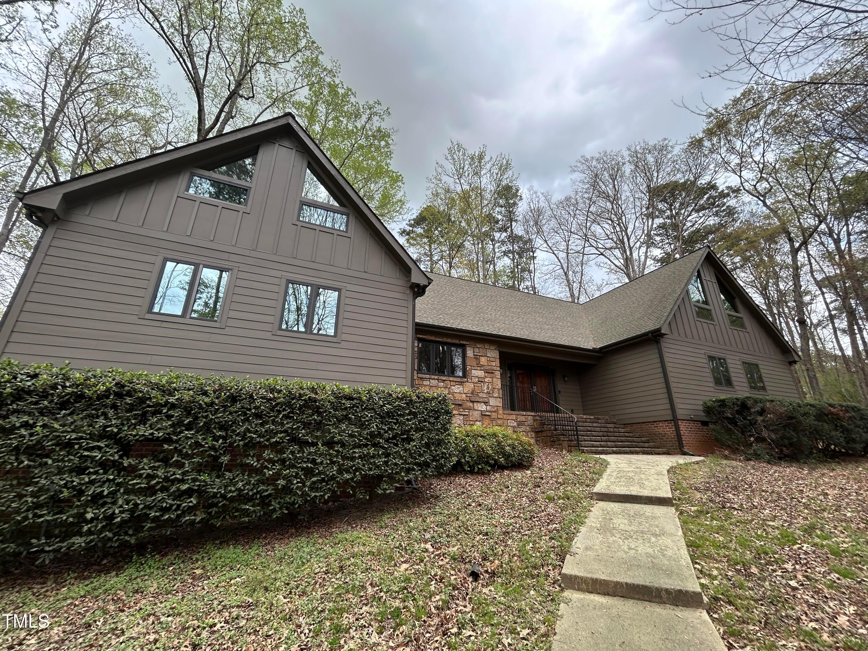 106 Springbrook Place Cary, NC 27518 - Photo 2 of 49 a front view of a house with garden