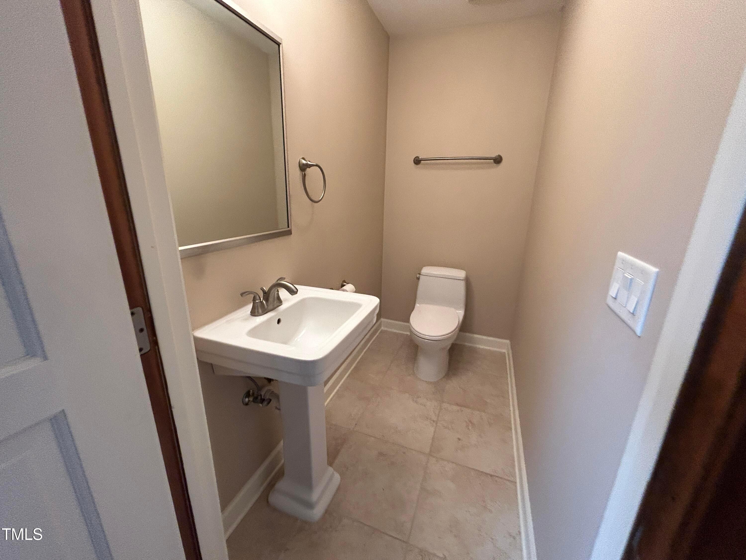 106 Springbrook Place Cary, NC 27518 - Photo 28 of 49 a bathroom with a sink a toilet and a mirror