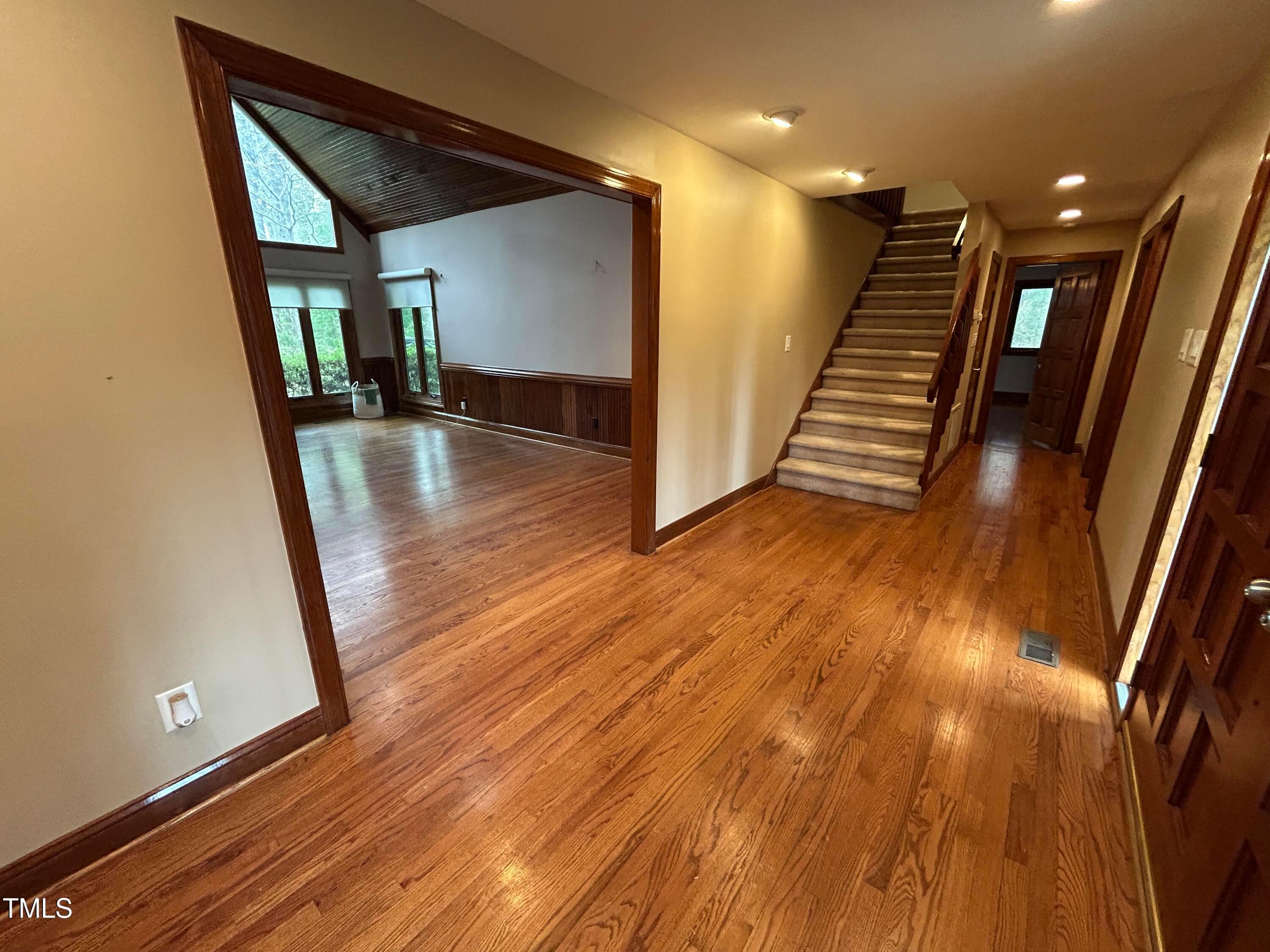 106 Springbrook Place Cary, NC 27518 - Photo 3 of 49 a view of a hallway with wooden floor and staircase