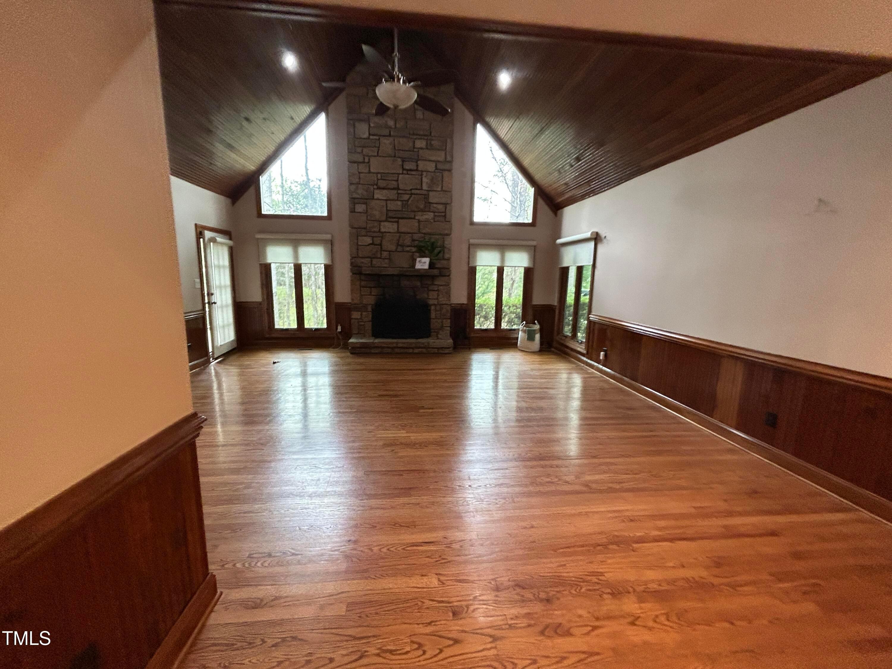 106 Springbrook Place Cary, NC 27518 - Photo 4 of 49 a view of empty room with wooden floor and fireplace