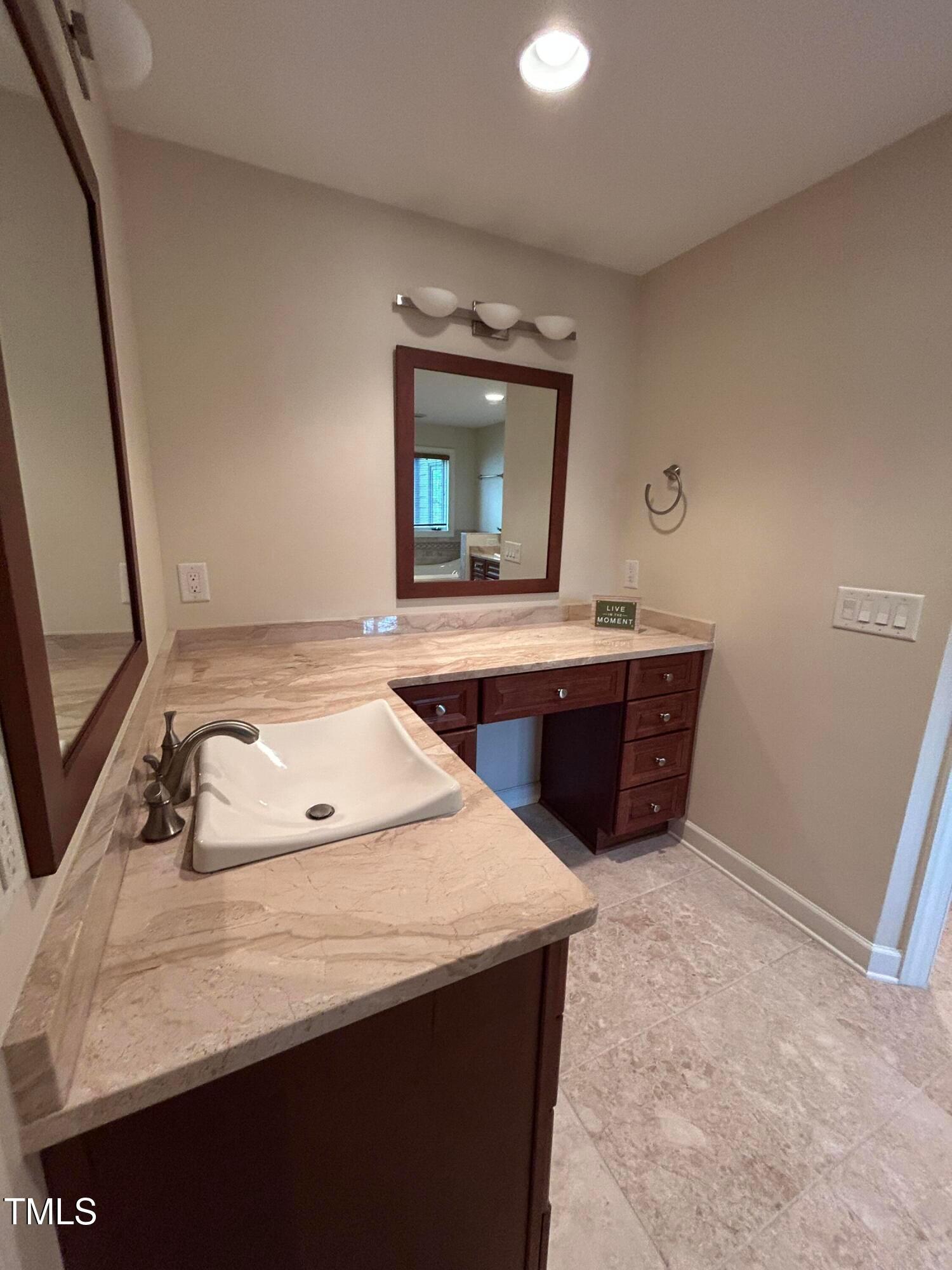 106 Springbrook Place Cary, NC 27518 - Photo 42 of 49 a bathroom with a sink and a mirror