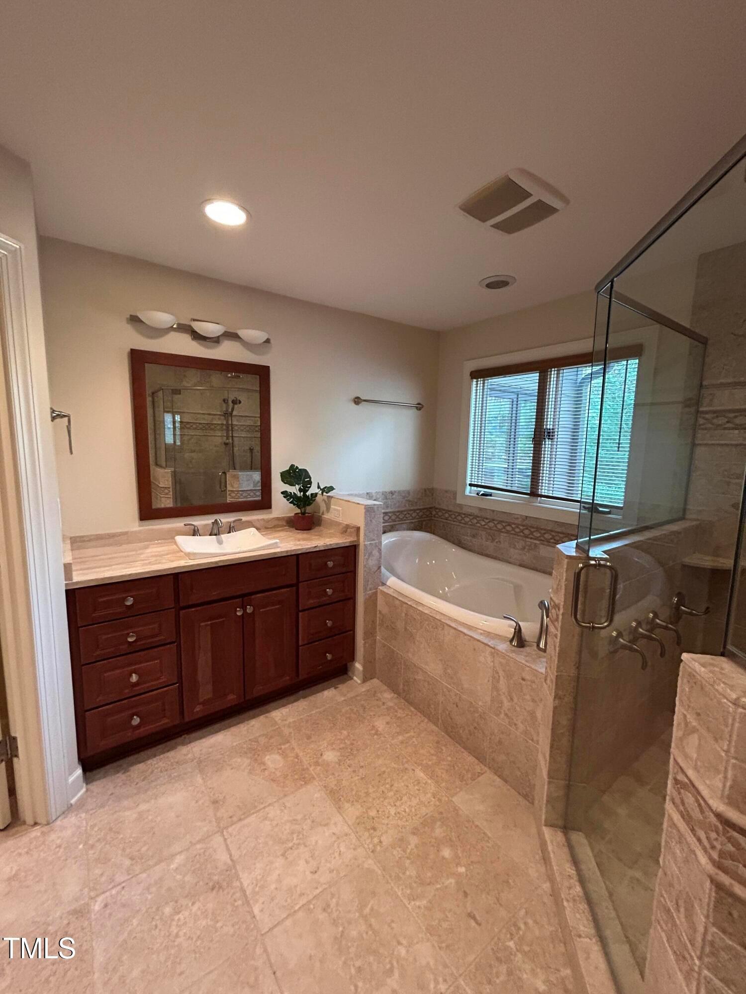 106 Springbrook Place Cary, NC 27518 - Photo 45 of 49 a bedroom with a bed and a mirror on the dresser
