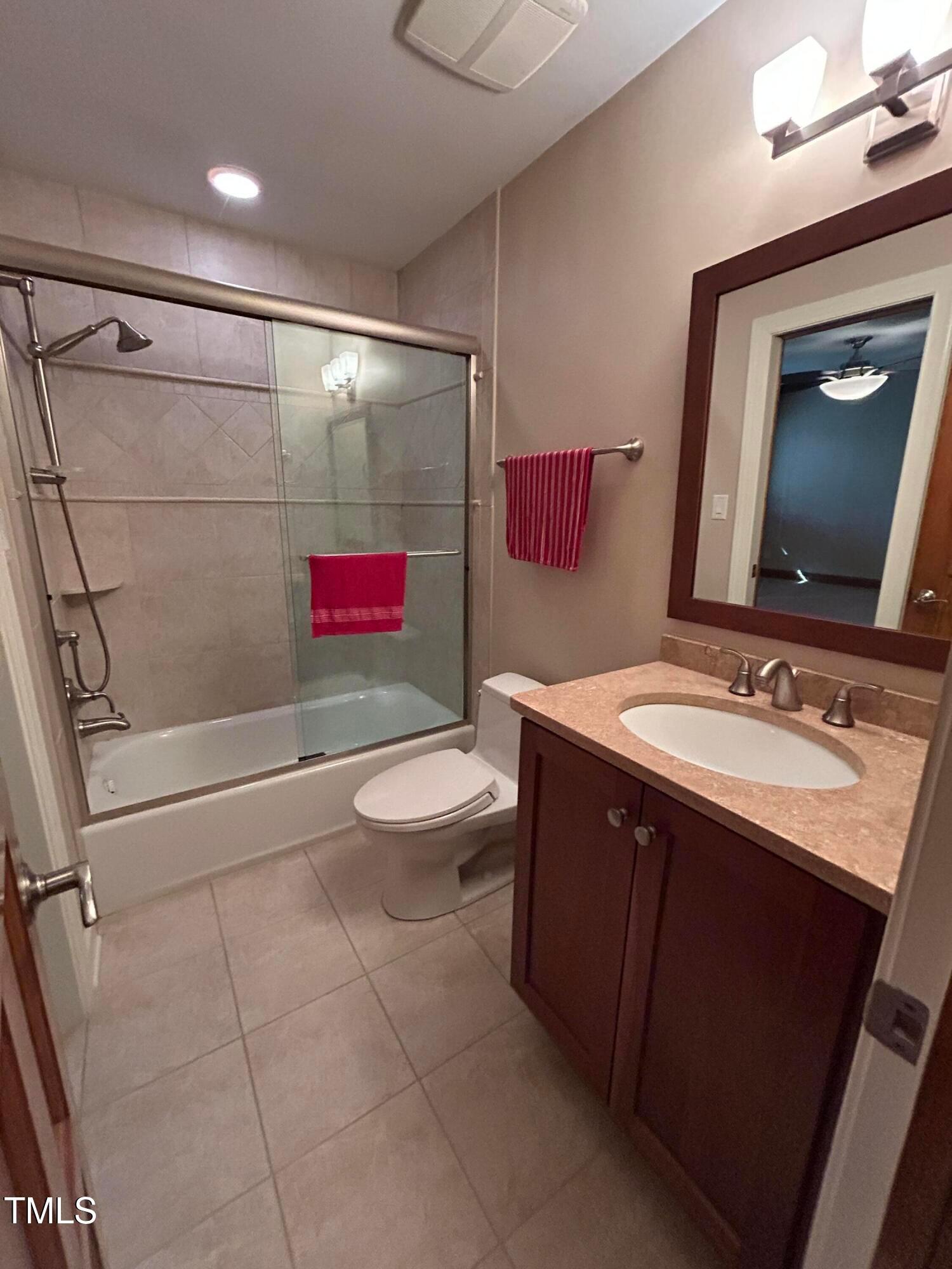 106 Springbrook Place Cary, NC 27518 - Photo 48 of 49 a bathroom with a sink a toilet and a shower