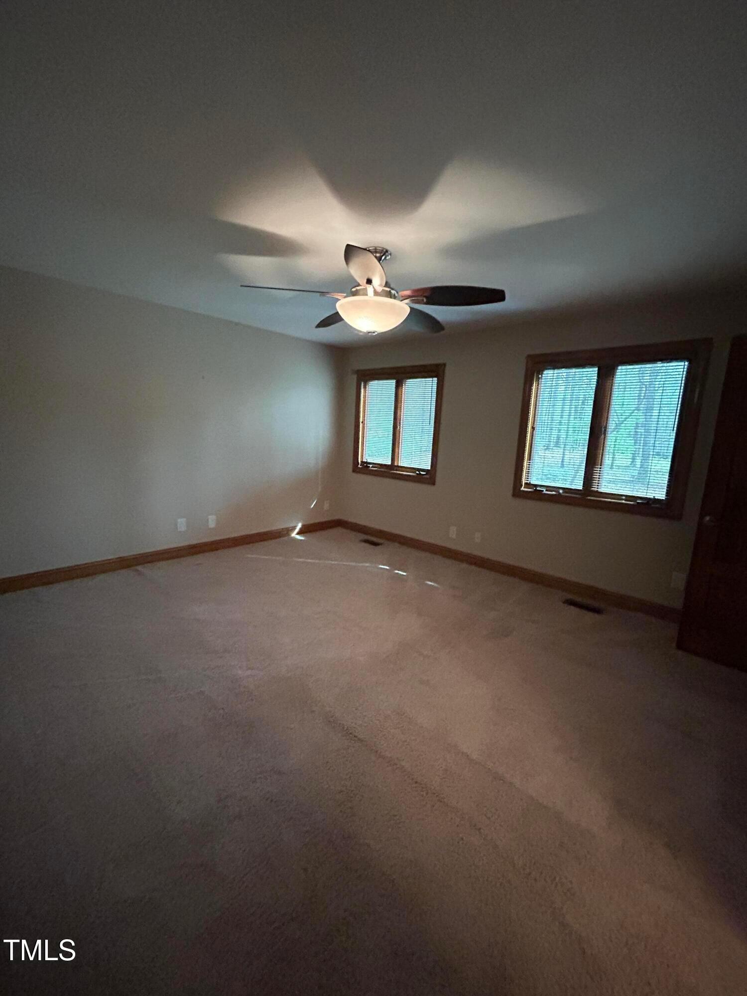 106 Springbrook Place Cary, NC 27518 - Photo 49 of 49 an empty room with windows and ceiling fan view