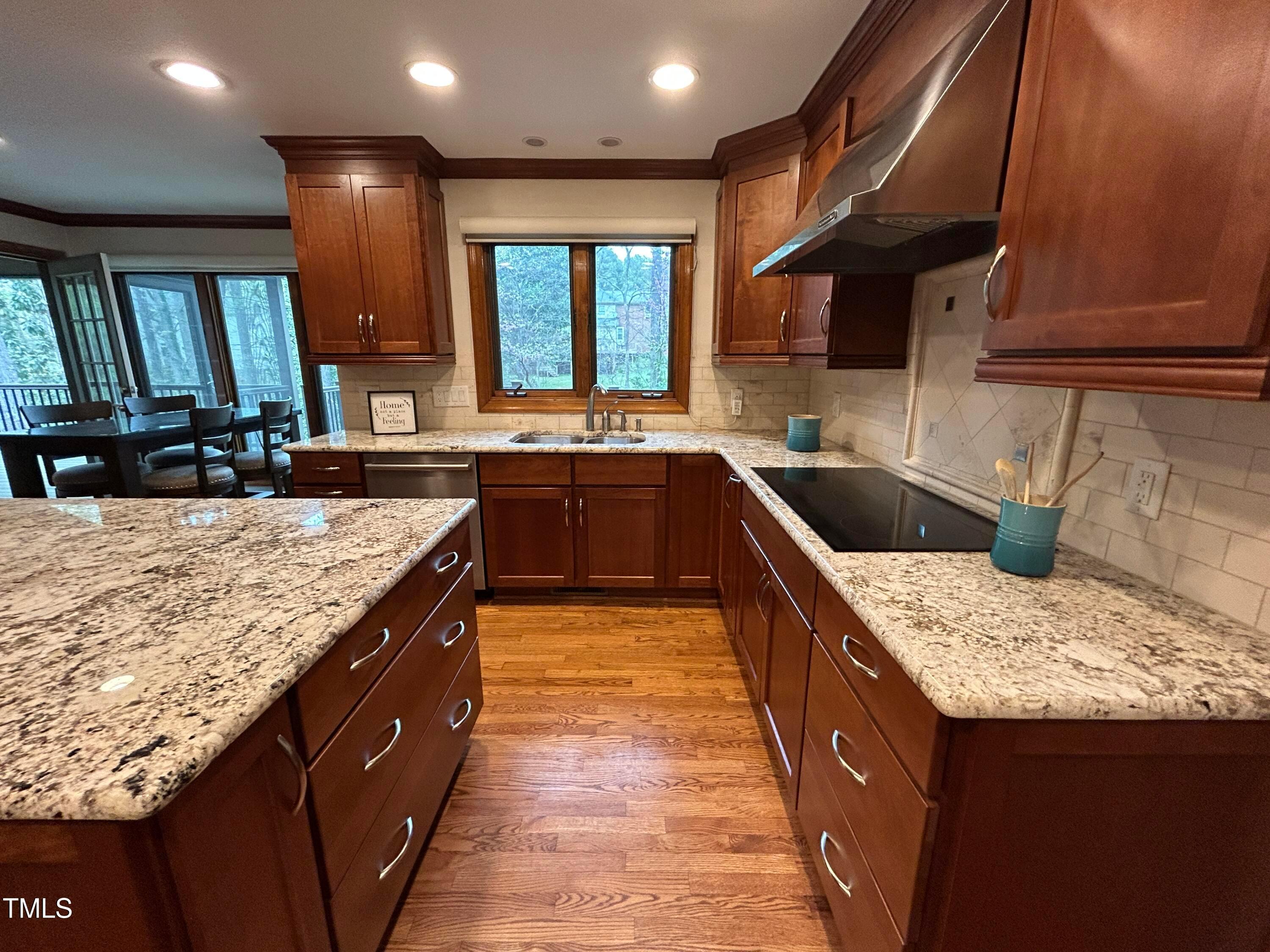 106 Springbrook Place Cary, NC 27518 - Photo 10 of 49 a kitchen with kitchen island granite countertop a sink stove and cabinets