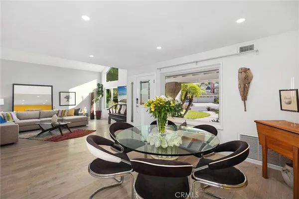 a dining room with furniture a rug and wooden floor