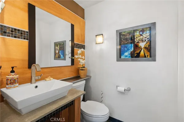 a bathroom with a toilet a sink and mirror